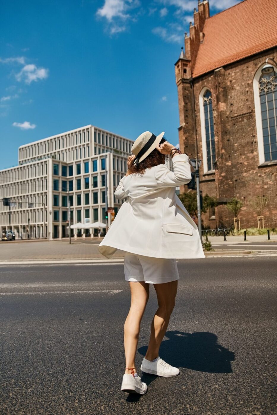 Stylish Traveler in White on a European Street