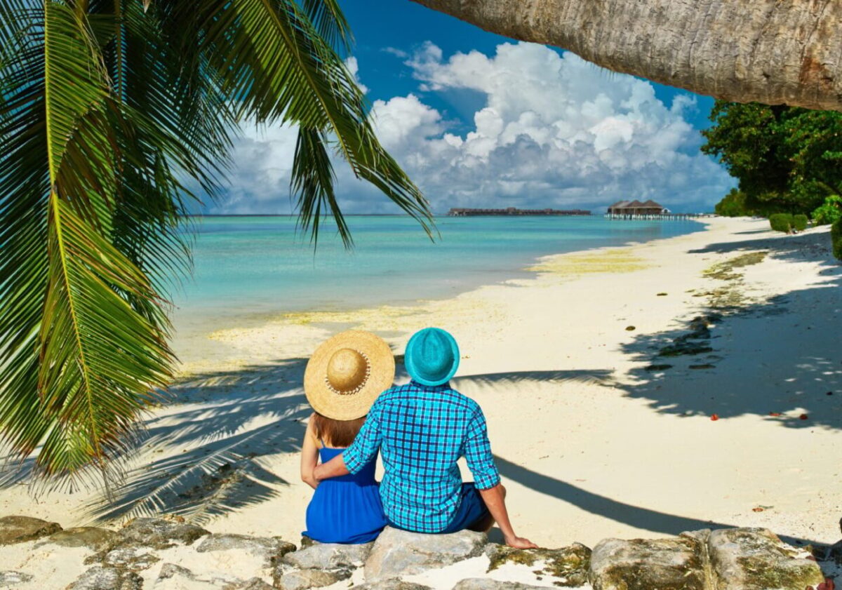 Couple in blue clothes on a beach at Maldives