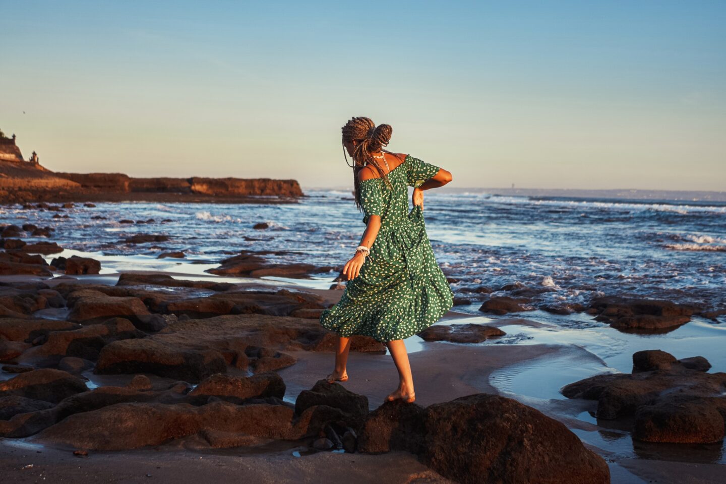 Woman walking on beach in bali at sunset