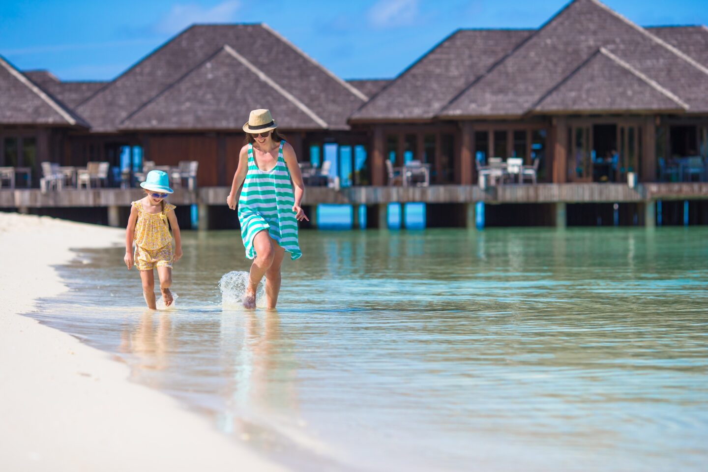 Mother and daughter enjoying time at tropical beach
